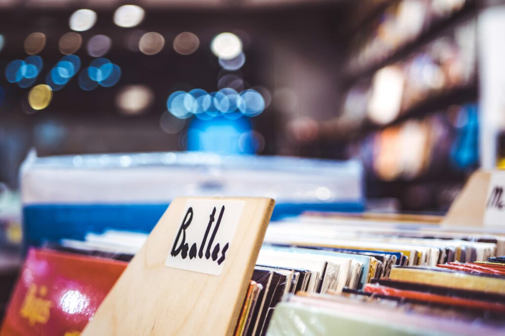 Explore a retro music store with vintage Beatles vinyl records on display.