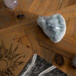 Close-up of raw crystals and tarot cards on a wooden surface, creating a mystical atmosphere.