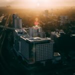 Aerial view of Miami's urban skyline at sunset, featuring traffic and modern buildings.