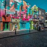 Vibrant street art and shops in a lively Dublin city street.
