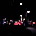 Blurred urban nighttime scene with colorful bokeh lights creating a dreamy effect.